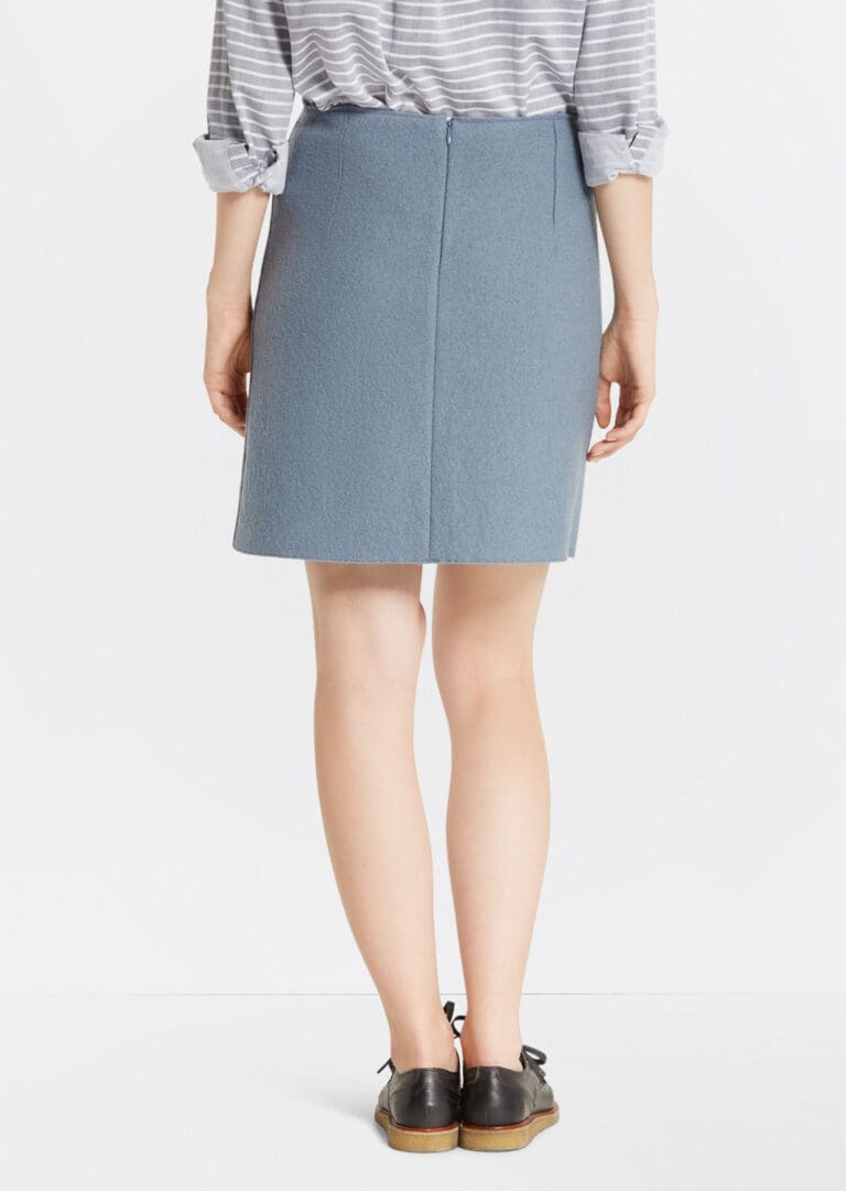 Woman wearing blue skirt and black shoes