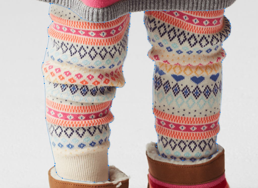Colorful patterned leg warmers worn over boots