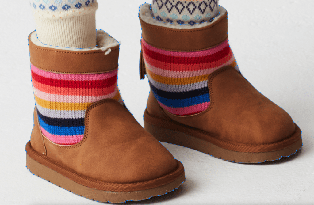 Person wearing colorful striped socks and brown boots