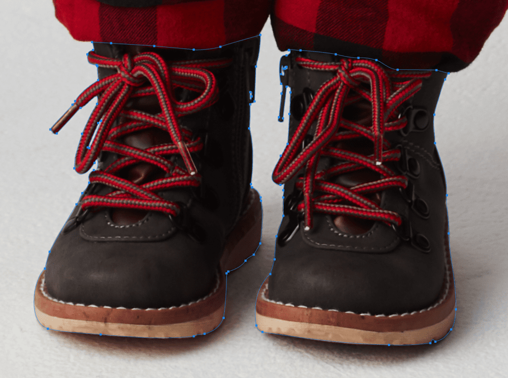 Dark brown boots with red laces on person